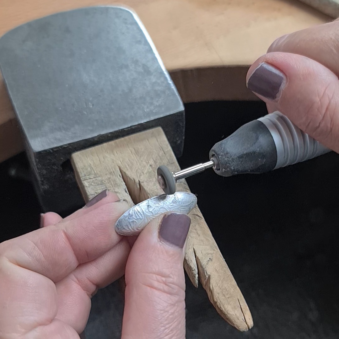 image shows the solder seam being tidyed up with an abrasive tool